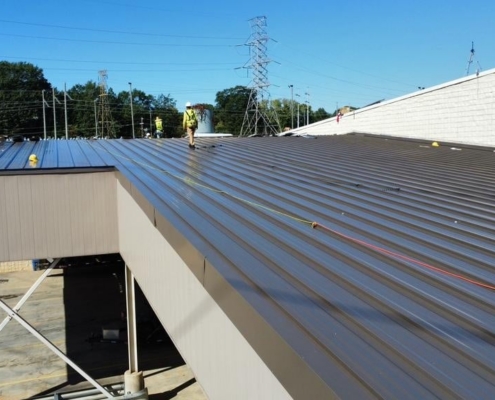 Classic architectural roof design with GAF asphalt shingles on a brick fire station building