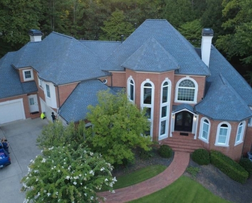 Upscale brick home with Gerard stone-coated metal shingles providing durability and elegance