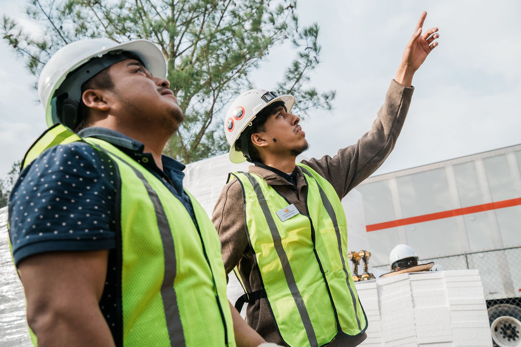 Roofer loading TPO rolls onto supply pallet for project