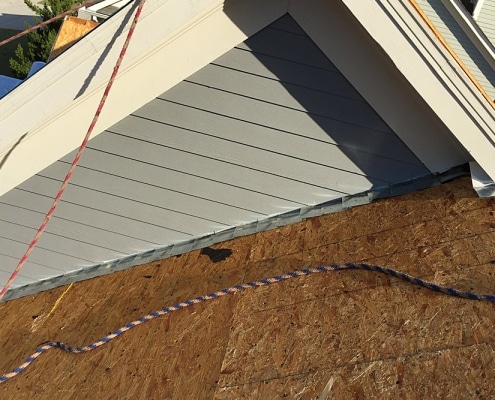 roof-repair-marietta-1 Ongoing roof repair with flashing replacement on sloped roof