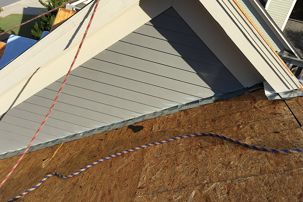 roof-repair-marietta-1 Ongoing roof repair with flashing replacement on sloped roof