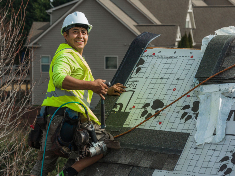 Workers analyzing roofing work from ground