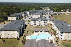 Aerial view of a large apartment complex in Atlanta, GA with well-maintained commercial roofing and a swimming pool