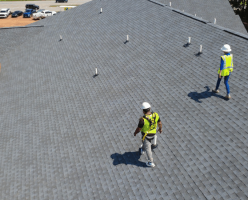 Academy Roofing inspectors evaluating roof safety and insurance compliance