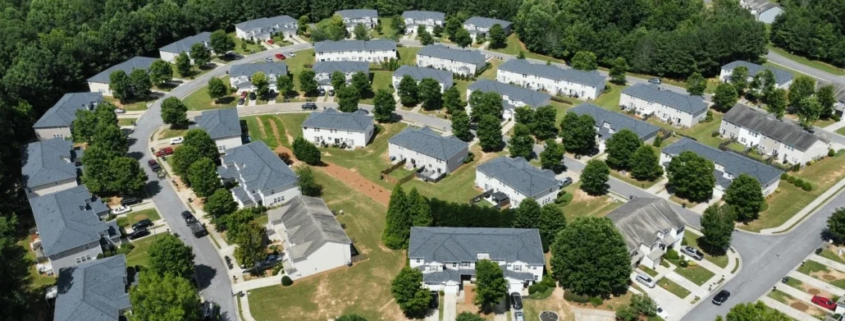 Aerial photo of residential neighborhood in Acworth, GA showing rooftops and surrounding trees