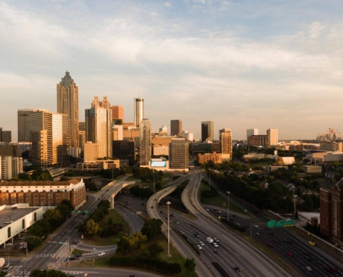 Downtown Atlanta skyline showing commercial buildings and highway, representing the region impacted by 2026 commercial roofing code updates