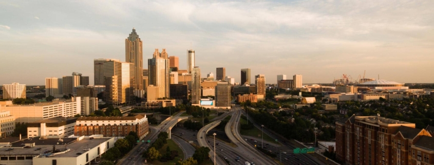 Downtown Atlanta skyline showing commercial buildings and highway, representing the region impacted by 2026 commercial roofing code updates