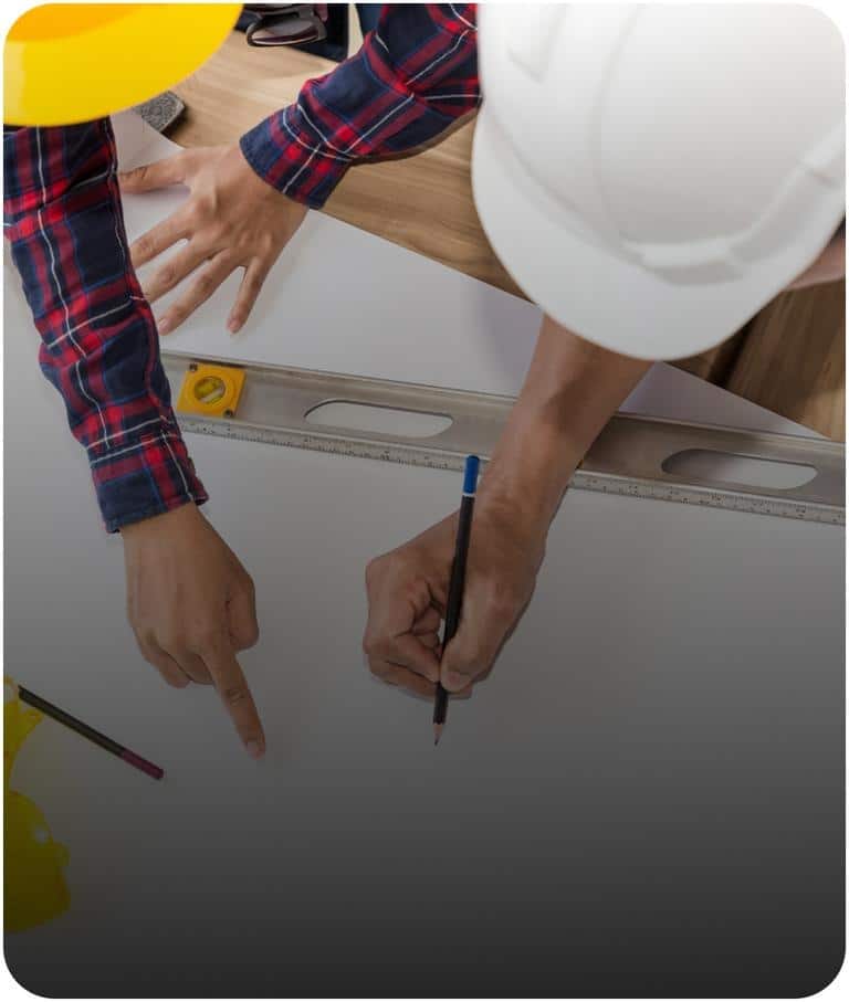 Commercial roofing team reviewing blueprints and measuring tools during scope planning meeting