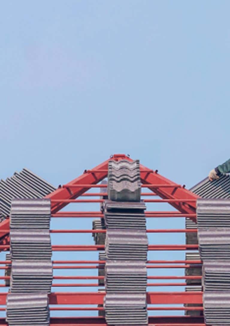 Roofing materials staged on top of a commercial building during tile installation preparation