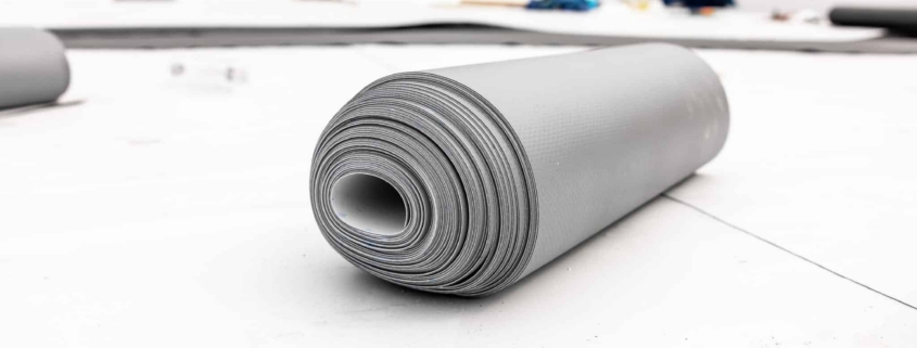 Roll of TPO roofing material on a flat commercial rooftop in Greater Atlanta