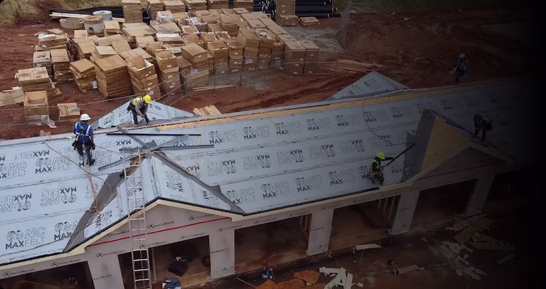 Aerial view of commercial roof construction project during early installation phase