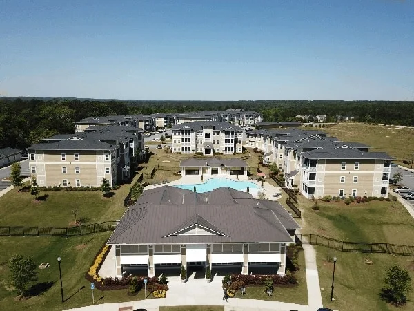 Aerial view of large property roofing project used to represent planning across multiple buildings