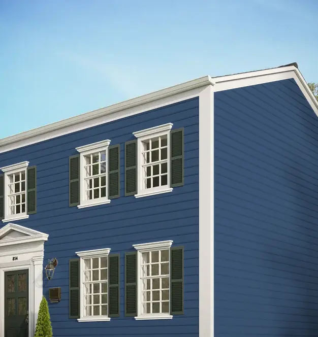 Traditional two-story home featuring blue horizontal siding, white trim, and dark shutters.